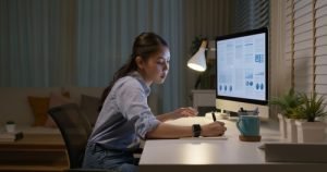 Woman at desk with a computer screen