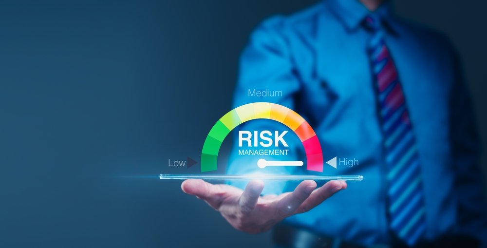 Businessman,Analyzes,Risk,Scale,On,Tablet.,Concept:,Financial,Management,Strategies
