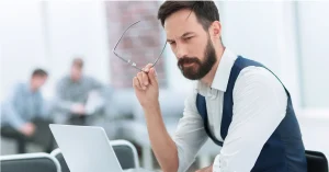 Thoughtful businessman sitting at an office desk